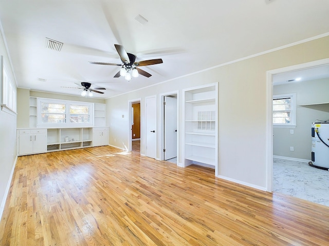 unfurnished living room with light wood-type flooring, built in features, and crown molding