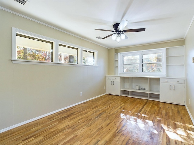 unfurnished bedroom with light wood-type flooring, ceiling fan, and crown molding