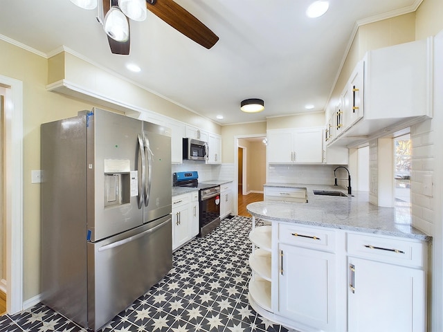 kitchen featuring ceiling fan, sink, white cabinets, and stainless steel appliances