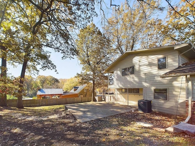 view of side of home with a patio and central AC