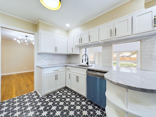 kitchen with crown molding, sink, stainless steel dishwasher, light stone counters, and white cabinetry