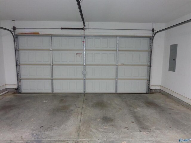  - garage featuring electric panel and baseboards