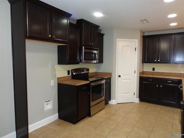  - kitchen with light tile patterned floors, baseboards, recessed lighting, appliances with stainless steel finishes, and tasteful backsplash