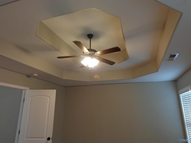  - interior details with a tray ceiling, a ceiling fan, and visible vents