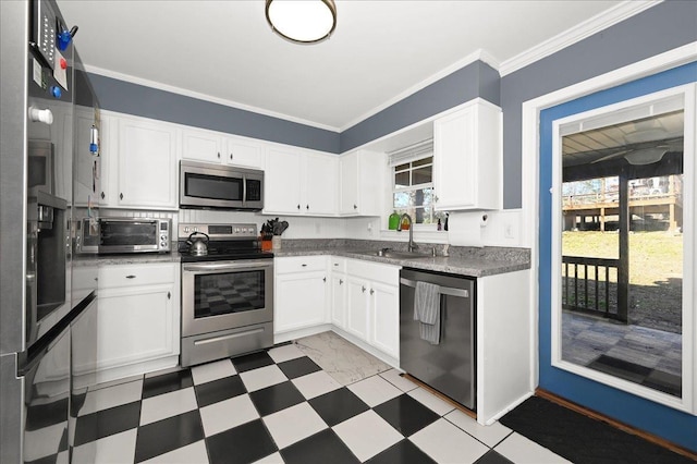 kitchen featuring white cabinetry, sink, plenty of natural light, and appliances with stainless steel finishes