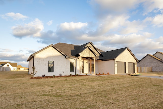 view of front of house featuring a garage and a front lawn