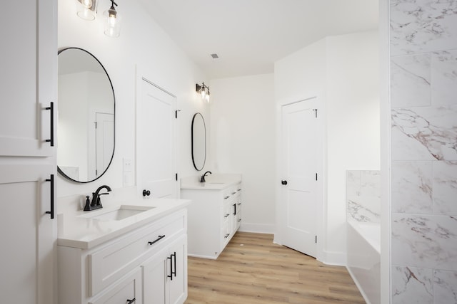 bathroom with vanity and hardwood / wood-style flooring