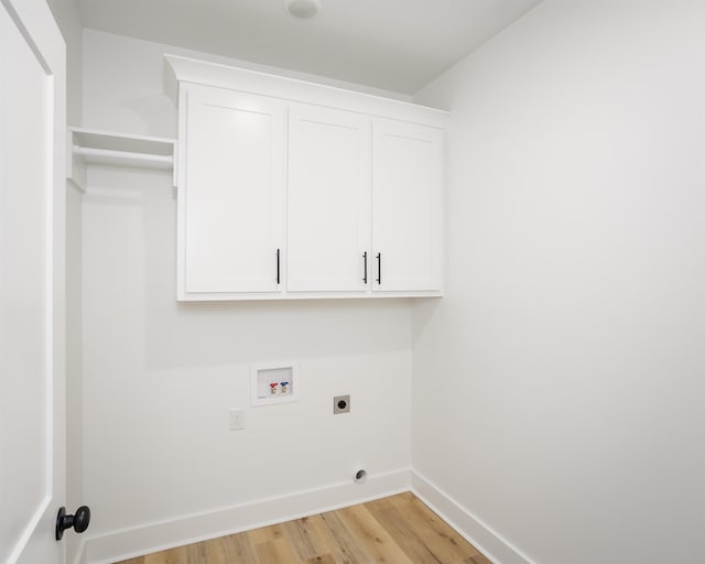 laundry room with washer hookup, cabinets, light hardwood / wood-style flooring, and hookup for an electric dryer