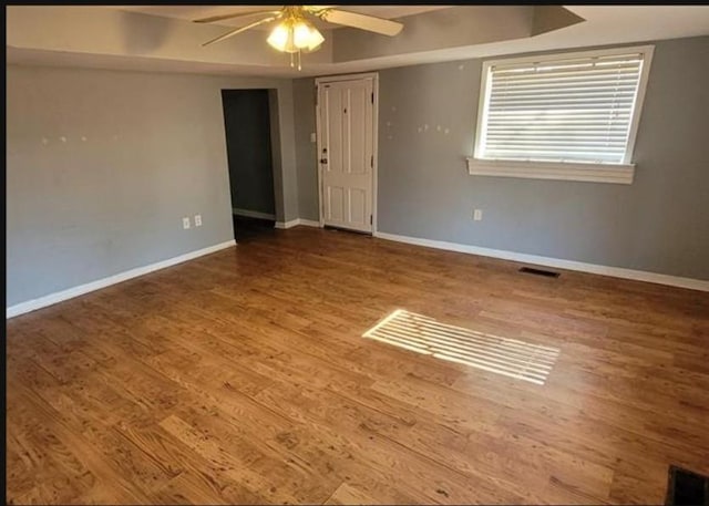 spare room with wood-type flooring and ceiling fan