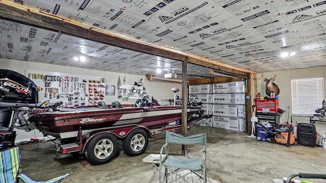 garage with a garage door opener and a workshop area