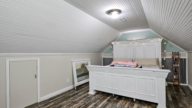 bedroom with lofted ceiling, dark wood finished floors, and baseboards