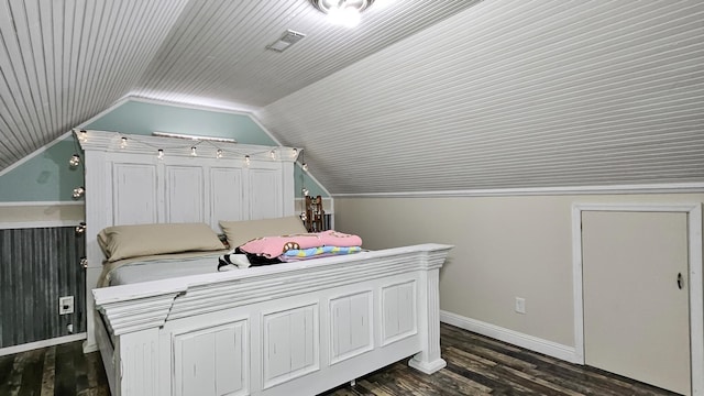 bedroom with lofted ceiling, dark wood finished floors, visible vents, and baseboards