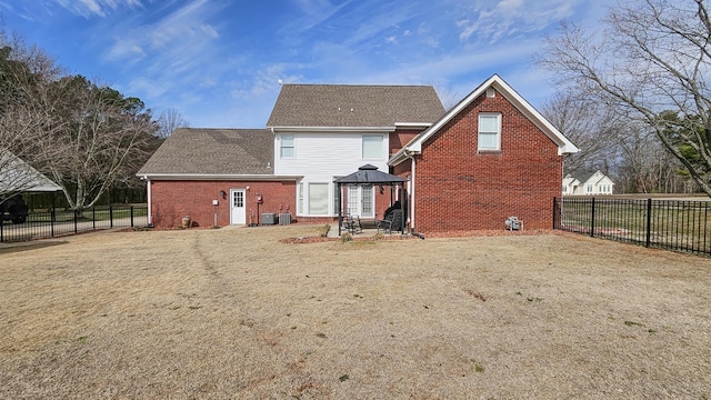 rear view of house featuring central air condition unit, a gazebo, fence, and brick siding