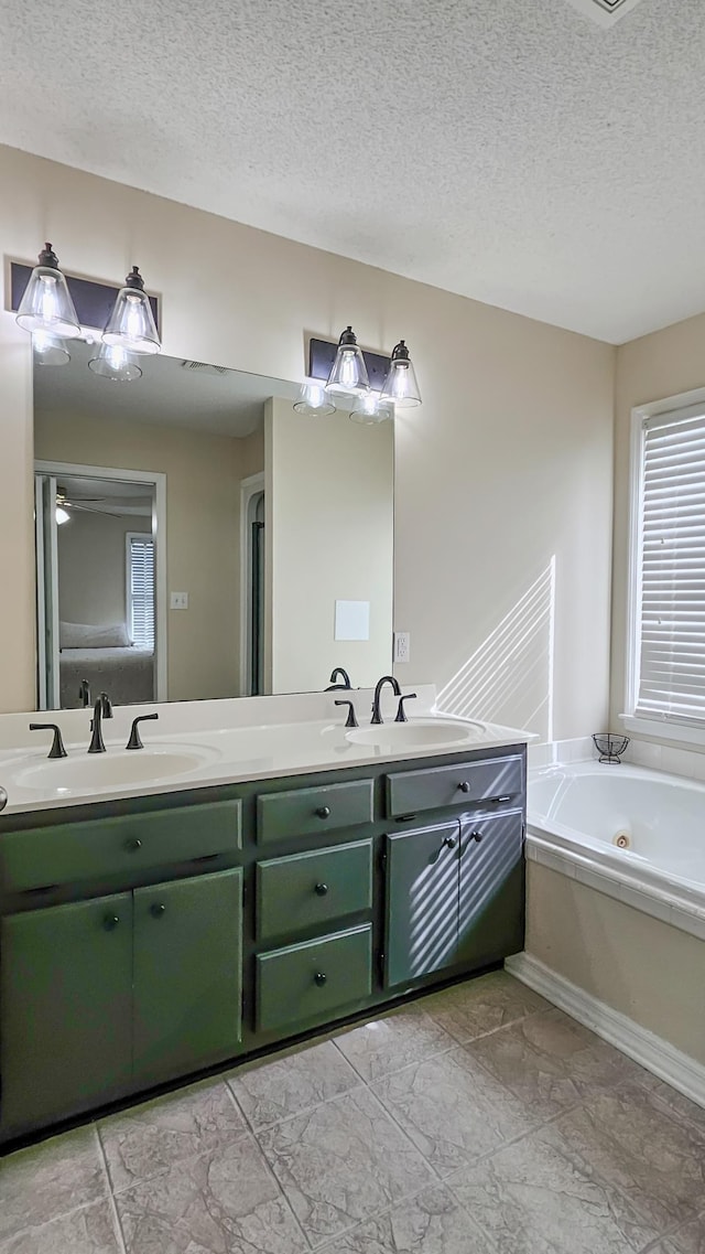 full bathroom with double vanity, a sink, and a whirlpool tub