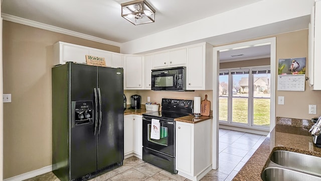 kitchen with black appliances, ornamental molding, a sink, and white cabinets