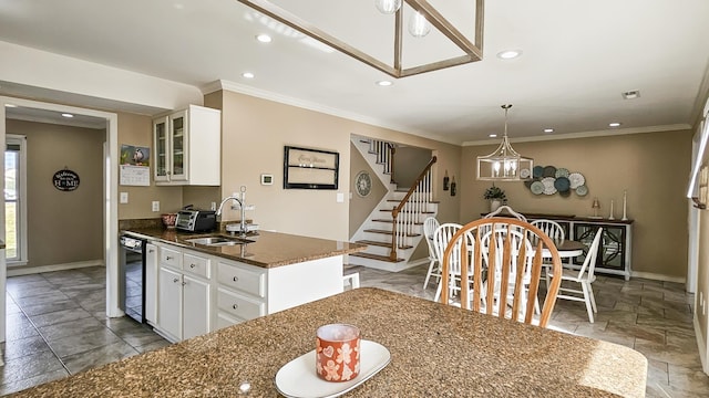 kitchen featuring dishwasher, crown molding, glass insert cabinets, and a sink