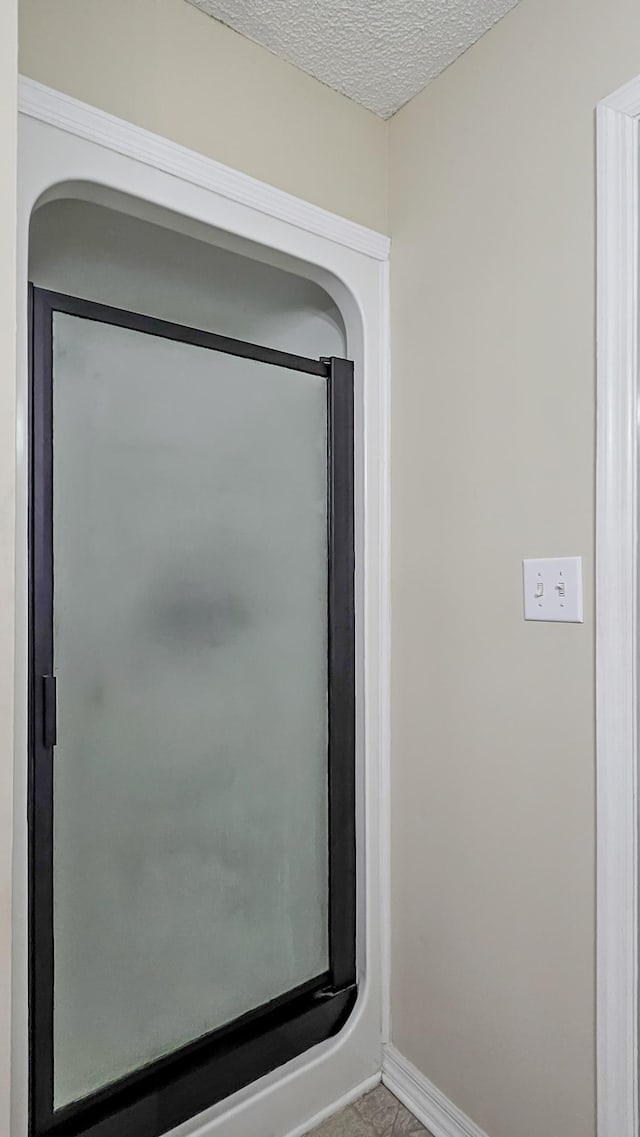 details with baseboards and a textured ceiling