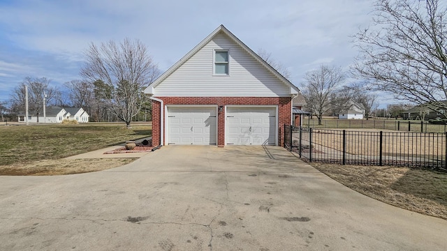 garage with driveway and fence