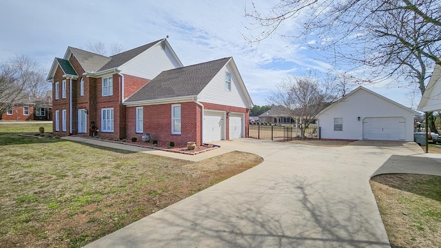 view of home's exterior with an attached garage, brick siding, fence, concrete driveway, and a lawn