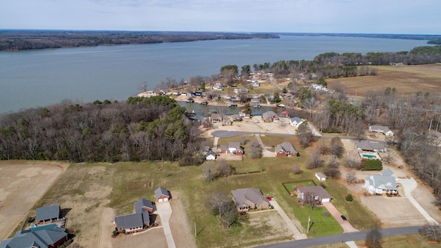 drone / aerial view featuring a water view and a wooded view