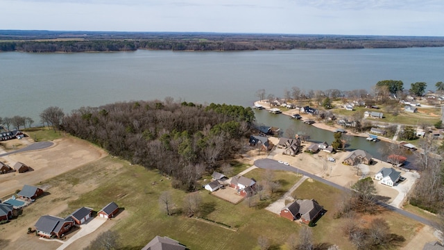 bird's eye view with a water view and a wooded view