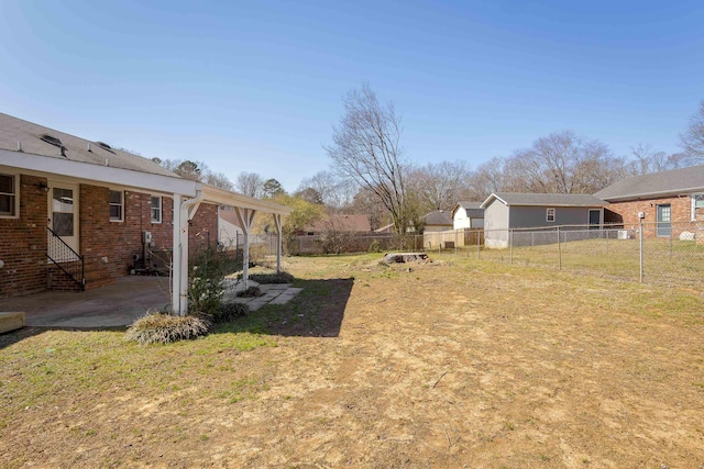 view of yard featuring entry steps, a patio, and a fenced backyard