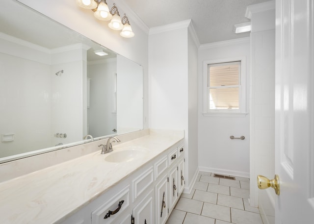 full bath featuring a textured ceiling, vanity, baseboards, ornamental molding, and tile patterned floors