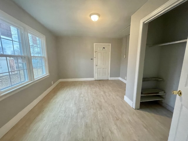 interior space featuring light wood-style flooring and baseboards