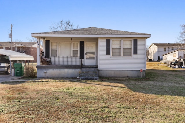 bungalow-style house featuring covered porch and a front yard