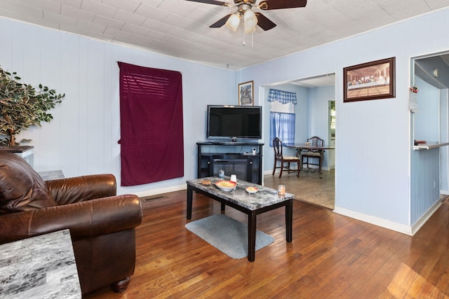 living room featuring dark hardwood / wood-style floors and ceiling fan