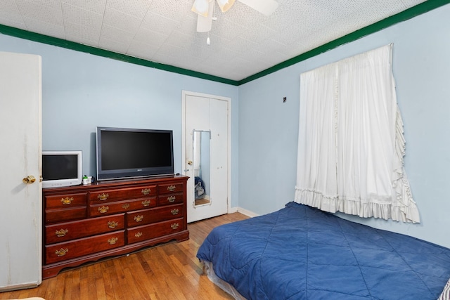 bedroom featuring multiple windows, ceiling fan, and light hardwood / wood-style floors