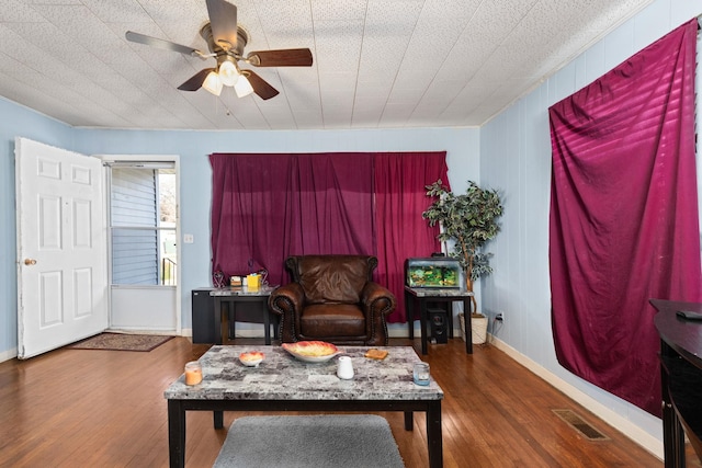 sitting room featuring ceiling fan and dark wood-type flooring