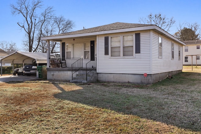 view of front of house with a carport, covered porch, and a front yard