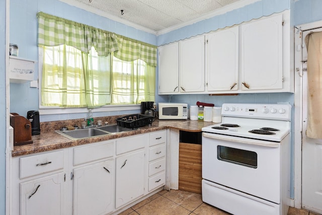 kitchen featuring white cabinetry and white appliances