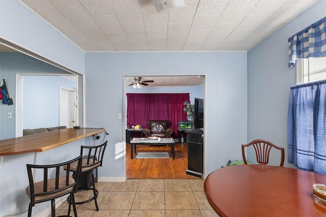 dining space with ceiling fan and light tile patterned flooring