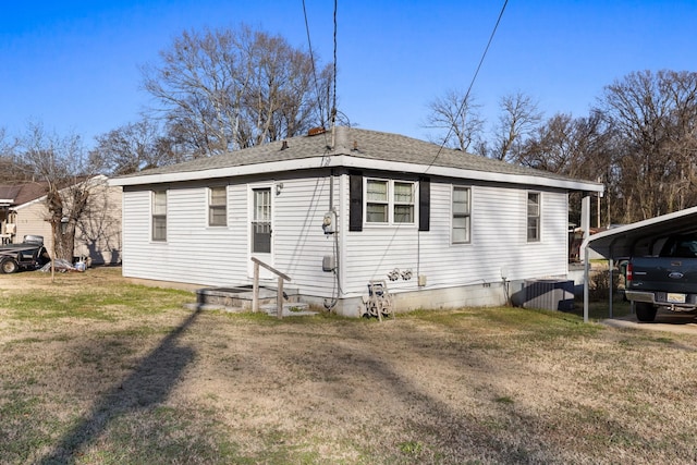 exterior space featuring a front lawn and a carport