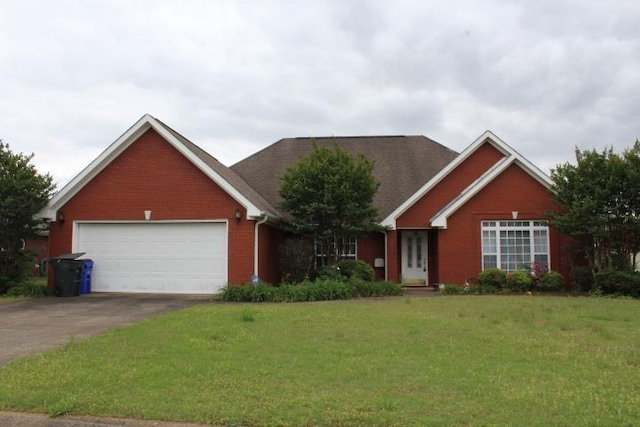 view of front of property featuring driveway, a front yard, an attached garage, and brick siding