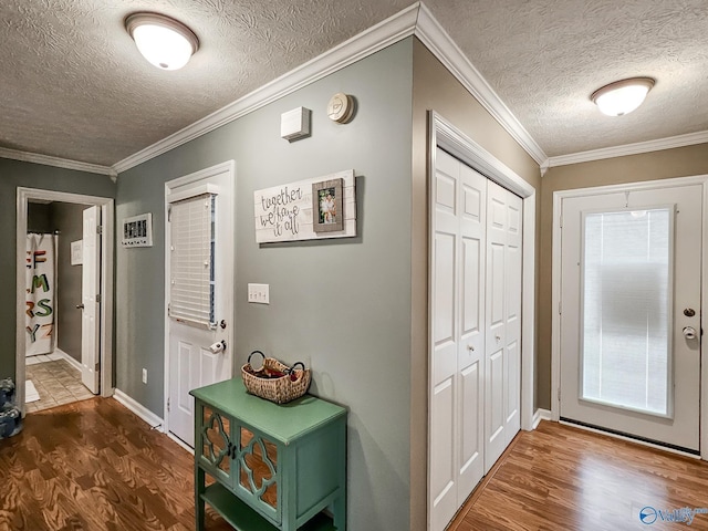 foyer featuring a textured ceiling, dark hardwood / wood-style floors, and crown molding