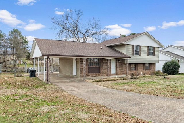 split level home with a front yard and a carport