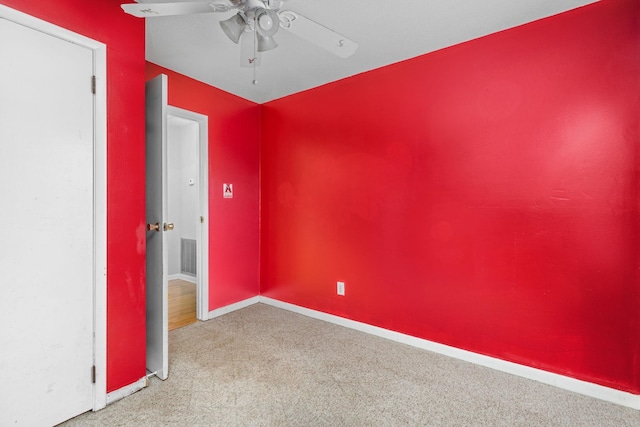 spare room featuring ceiling fan and light carpet