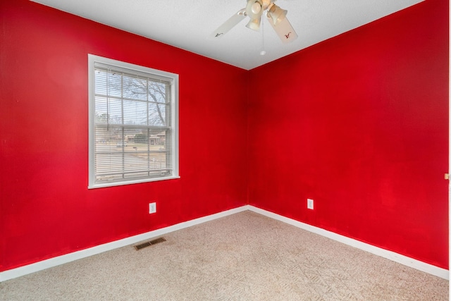 spare room with ceiling fan and carpet flooring