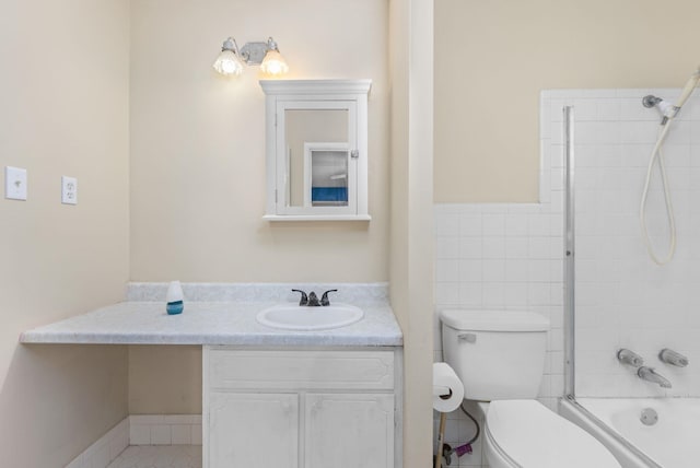 full bathroom featuring vanity, toilet, tiled shower / bath combo, and tile walls