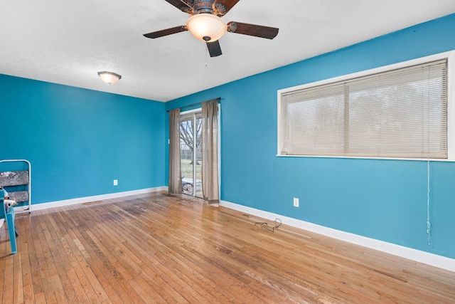 spare room with hardwood / wood-style flooring and ceiling fan