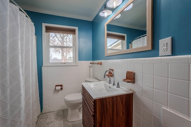 bathroom with toilet, crown molding, tile walls, vanity, and tile patterned flooring