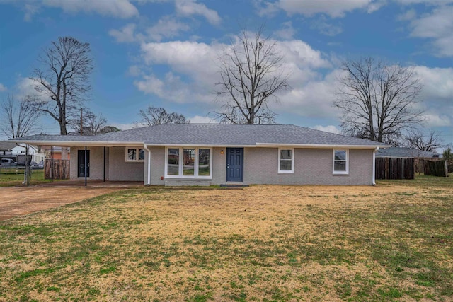 ranch-style house with a carport and a front lawn