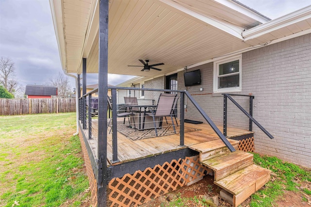 wooden terrace with a yard and ceiling fan