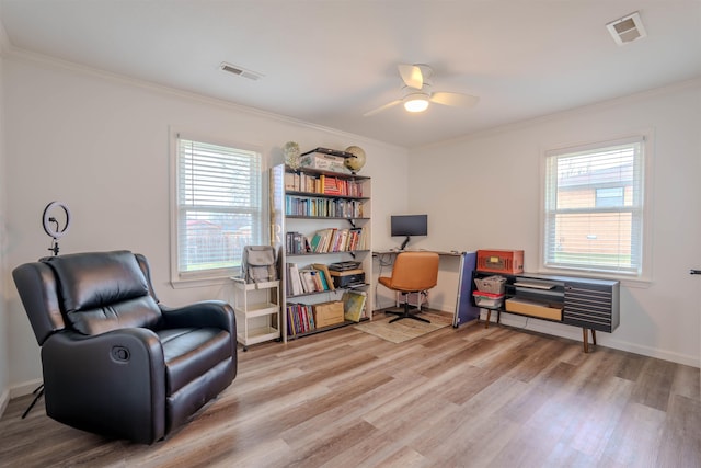 office area with ornamental molding, plenty of natural light, and light hardwood / wood-style floors