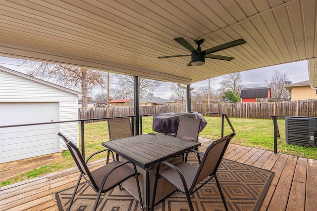 deck featuring ceiling fan, a yard, and area for grilling