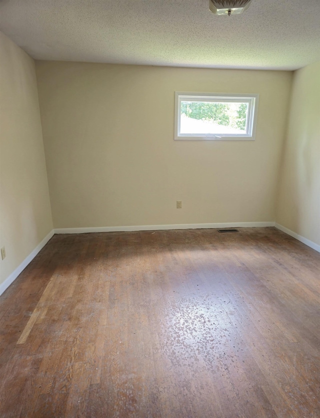  - spare room with wood finished floors and baseboards