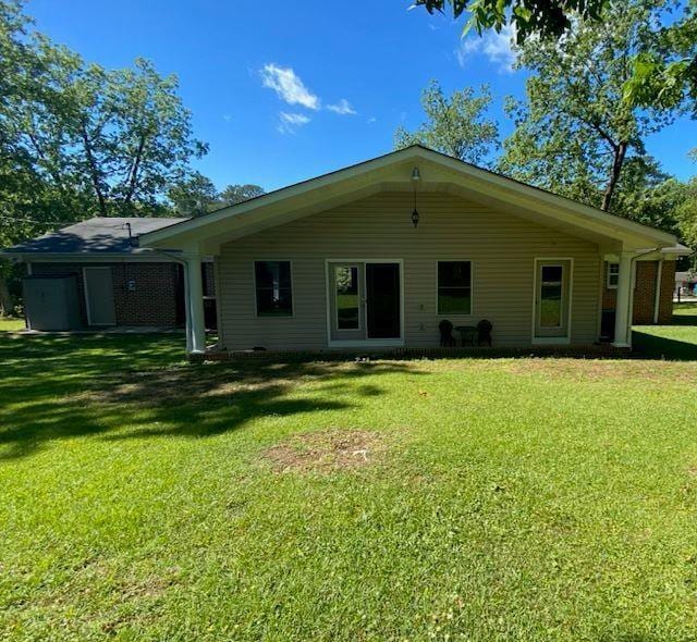  - back of property featuring a yard